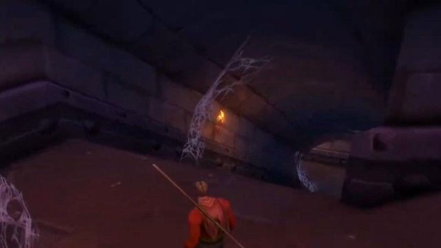 A Human Warlock walking past thick cobwebs in a dark stone corridor under the High Seat