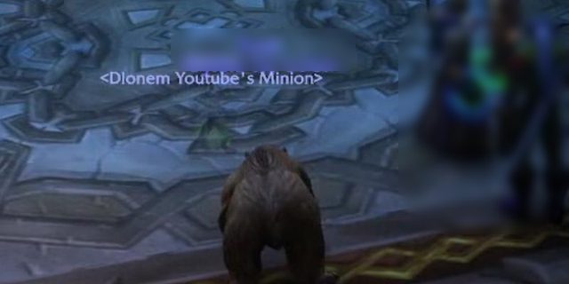 A nameplate reading Dlonem Youtube's Minion on a stone floor, with a bear pet in the foreground